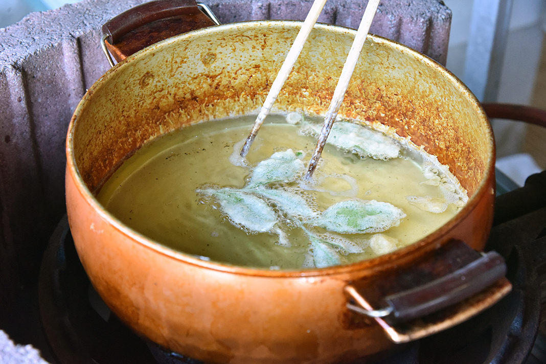 新芽を摘んでその場で天ぷらに。揚げたてサクサクの茶葉は茶園でしか味わえない味覚。爽やかさとほろ苦さ、ほんのり塩味が美味